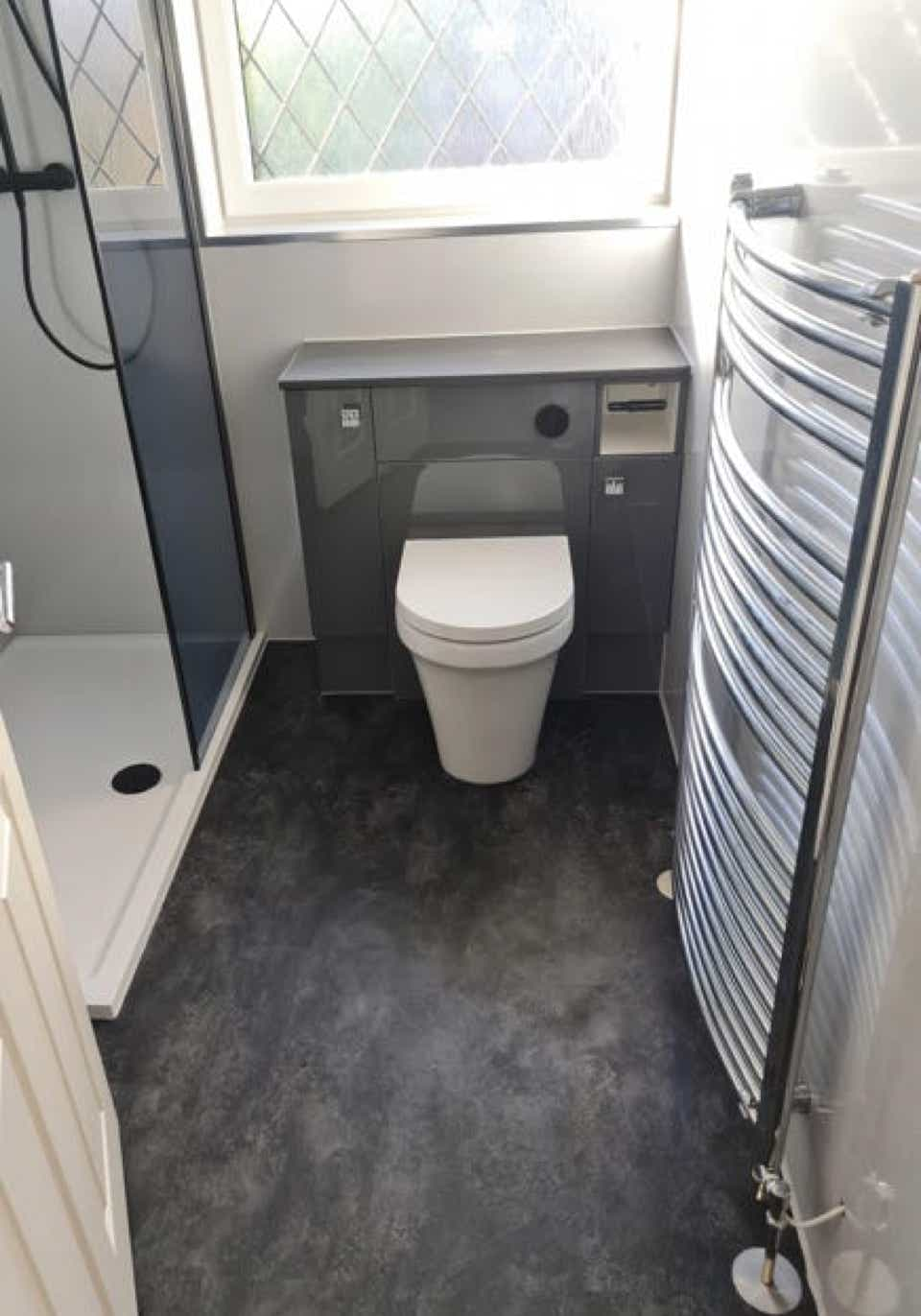 Image of a modern bathroom in grey and white with lvt flooring renovated by Plumb Yorkshire Ltd.