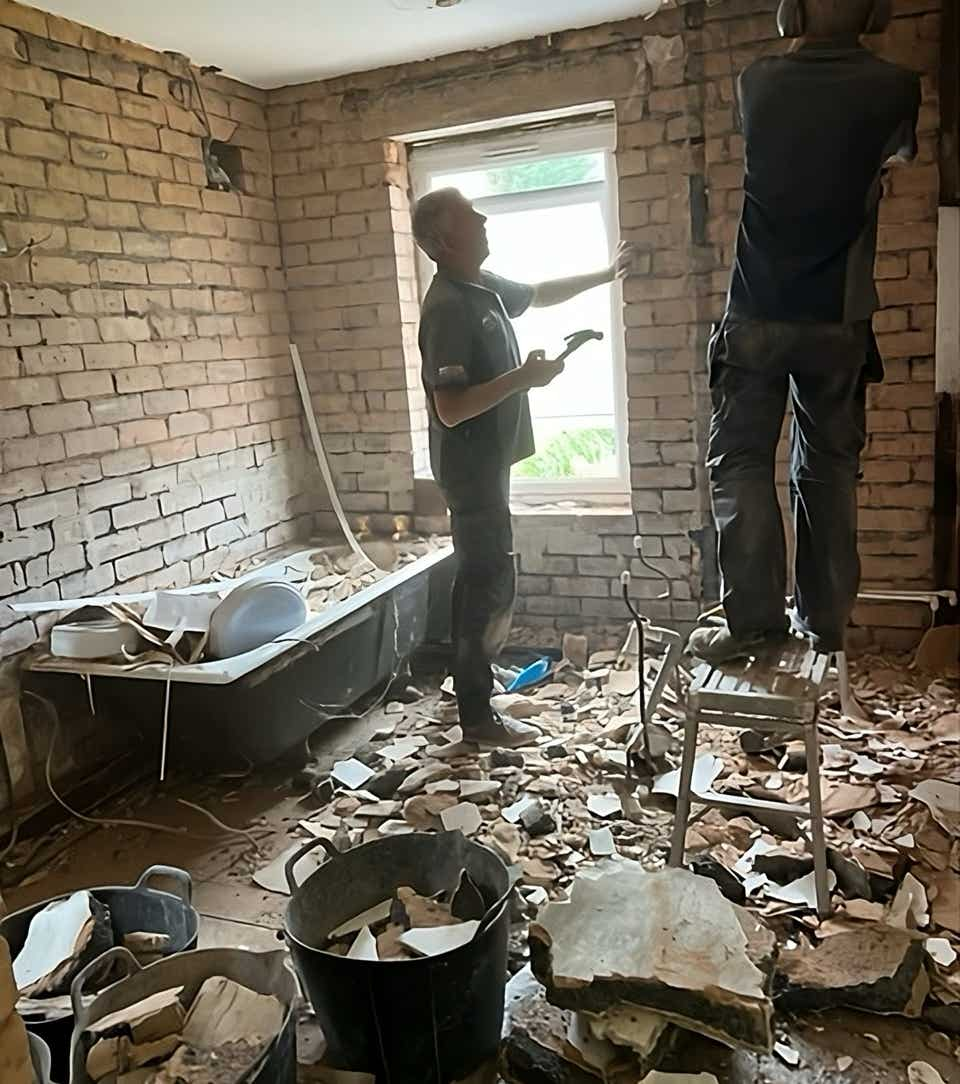 Image of Plumb Yorkshire Ltd. accredited workmen finishing ripping out an old bathroom ready for the new renovation.